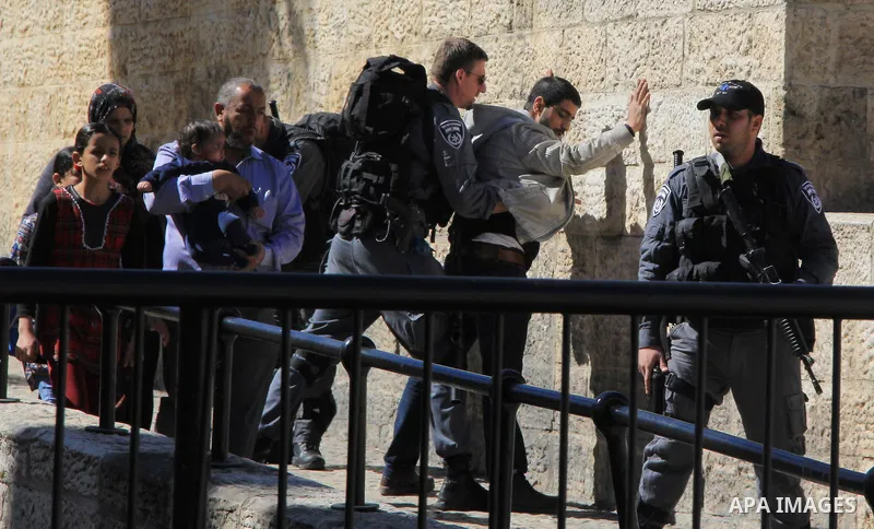 Israeli border policeman searches a Palestinian at the Old City's Damascus Gate in Jerusalem Friday, Feb. 19, 2016. The Damascus Gate has been the scene of numerous Palestinian attacks over the past few months and Israel...