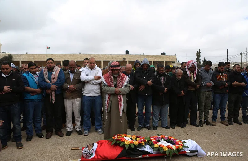 Mourners pray on the body of Abed Hammad, 20, who was shot dead by Israeli forces, during his funeral in the West Bank village of Silwad, Feb. 20, 2016. Hammad was one of three Palestinians to be killed by Israeli forces...