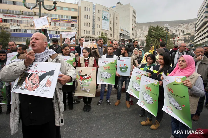 Palestinians chant slogans during a protest to demand the boycott of Israeli goods in the West bank city of Nablus, on Feb. 20, 2016. Photo by Nedal Eshtayah