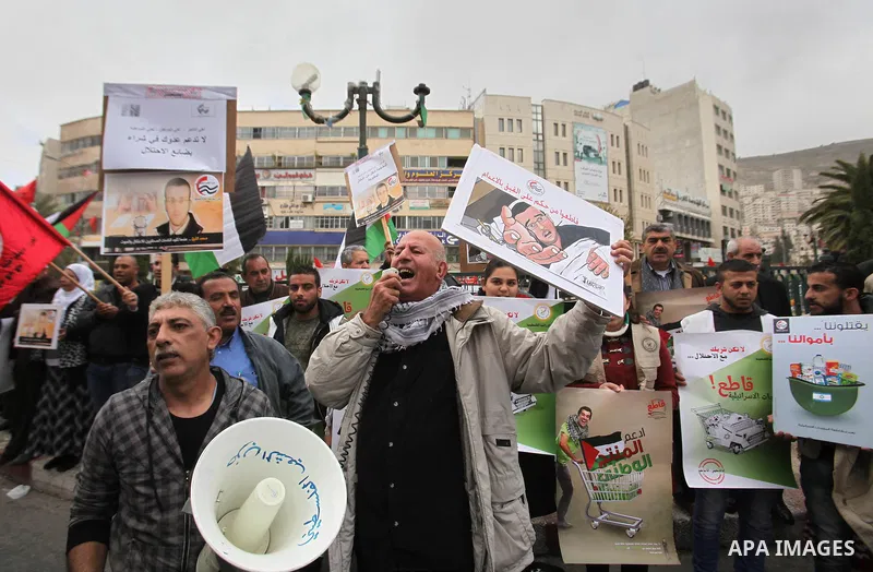 Palestinians chant slogans during a protest to demand the boycott of Israeli goods in the West bank city of Nablus, on Feb. 20, 2016. Photo by Nedal Eshtayah