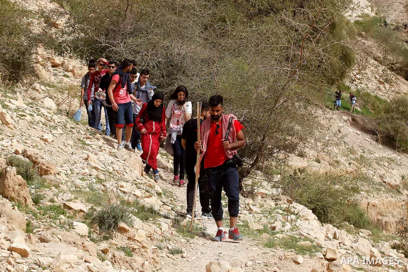 Palestinian youths walk on the mountains of Wadi Qelt, near the West Bank city of Jericho, on Feb 20, 2016. Wadi Qelt is a valley running west to east across the Judean desert in the West Bank, originating near Jerusalem...
