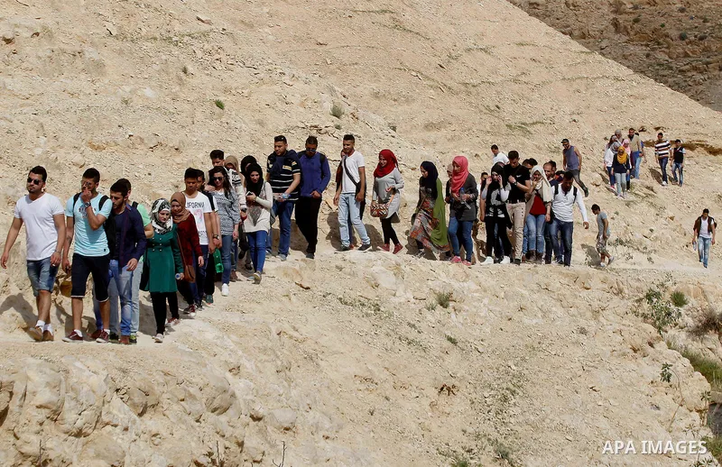 Palestinian youths walk on the mountains of Wadi Qelt, near the West Bank city of Jericho, on Feb 20, 2016. Wadi Qelt is a valley running west to east across the Judean desert in the West Bank, originating near Jerusalem...