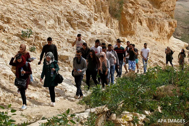 Palestinian youths walk on the mountains of Wadi Qelt, near the West Bank city of Jericho, on Feb 20, 2016. Wadi Qelt is a valley running west to east across the Judean desert in the West Bank, originating near Jerusalem...