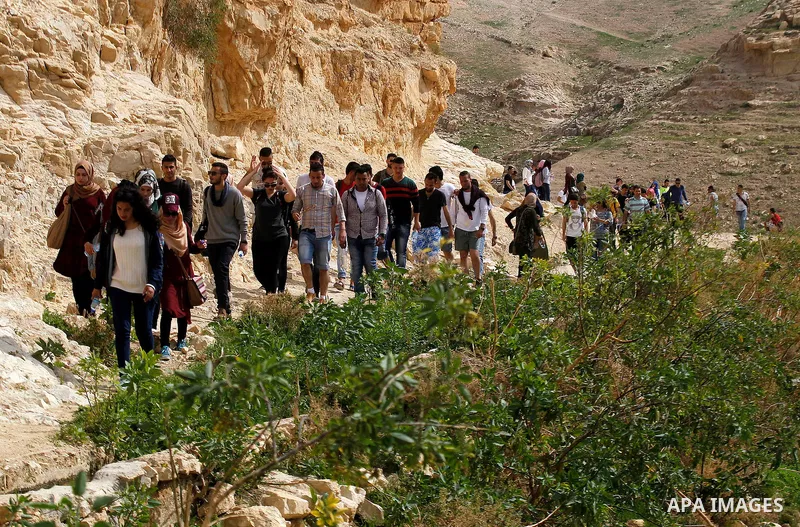 Palestinian youths walk on the mountains of Wadi Qelt, near the West Bank city of Jericho, on Feb 20, 2016. Wadi Qelt is a valley running west to east across the Judean desert in the West Bank, originating near Jerusalem...