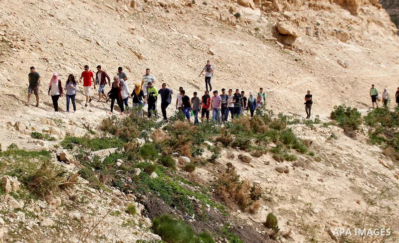 Palestinian youths walk on the mountains of Wadi Qelt, near the West Bank city of Jericho, on Feb 20, 2016. Wadi Qelt is a valley running west to east across the Judean desert in the West Bank, originating near Jerusalem...