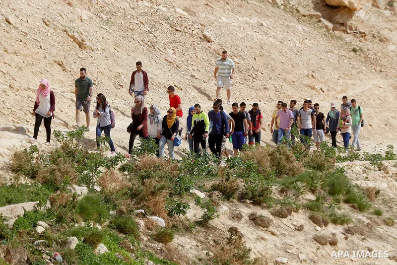 Palestinian youths walk on the mountains of Wadi Qelt, near the West Bank city of Jericho, on Feb 20, 2016. Wadi Qelt is a valley running west to east across the Judean desert in the West Bank, originating near Jerusalem...
