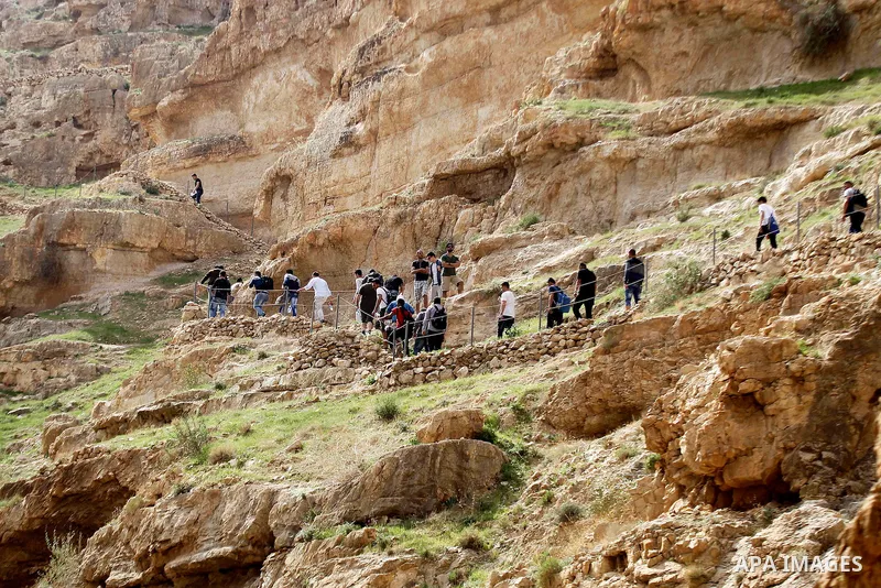 Palestinian youths walk on the mountains of Wadi Qelt, near the West Bank city of Jericho, on Feb 20, 2016. Wadi Qelt is a valley running west to east across the Judean desert in the West Bank, originating near Jerusalem...
