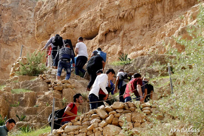 Palestinian youths walk on the mountains of Wadi Qelt, near the West Bank city of Jericho, on Feb 20, 2016. Wadi Qelt is a valley running west to east across the Judean desert in the West Bank, originating near Jerusalem...