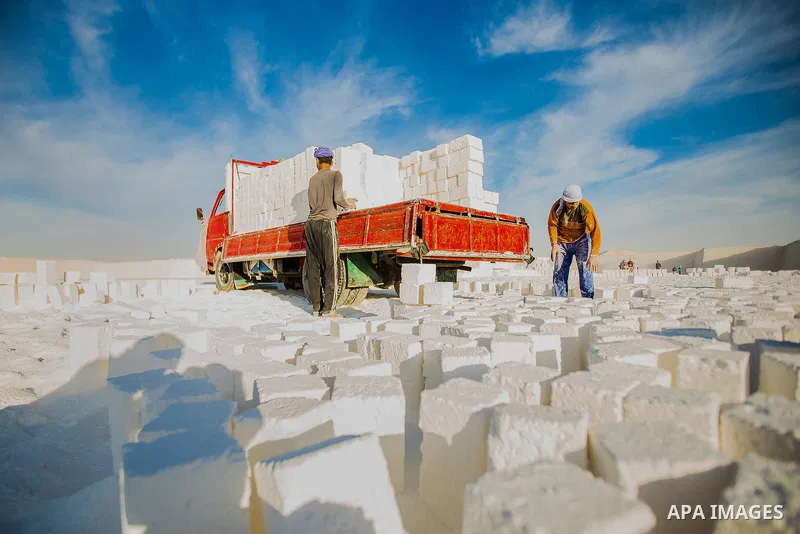 Egyptian Labourers work at a quarry in the desert of Minya governorate, south of Cairo, Egypt, on Feb 20, 2016. In the limestone quarries of Minya province south of Cairo, labourers in sandals and makeshift masks use uns...