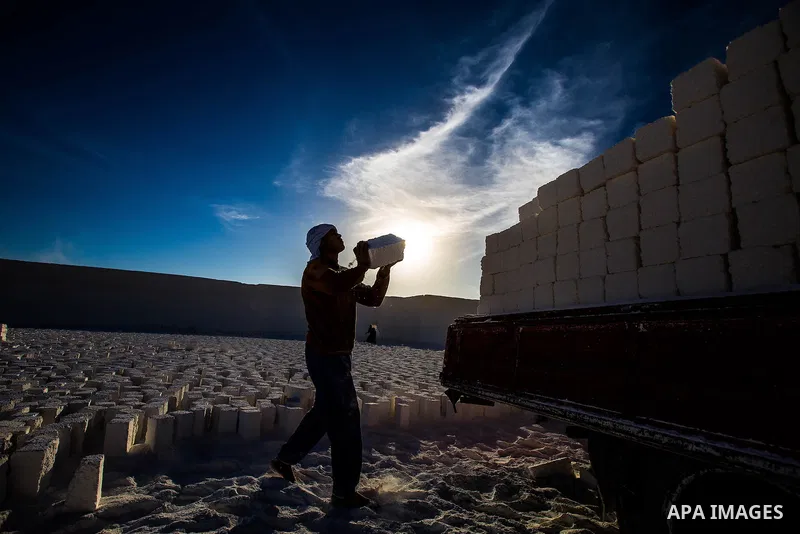 Egyptian Labourers work at a quarry in the desert of Minya governorate, south of Cairo, Egypt, on Feb 20, 2016. In the limestone quarries of Minya province south of Cairo, labourers in sandals and makeshift masks use uns...