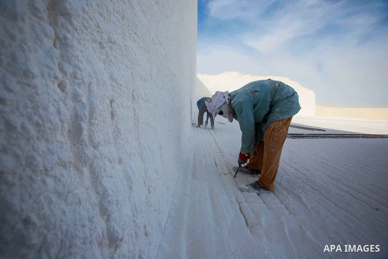 Egyptian Labourers work at a quarry in the desert of Minya governorate, south of Cairo, Egypt, on Feb 20, 2016. In the limestone quarries of Minya province south of Cairo, labourers in sandals and makeshift masks use uns...