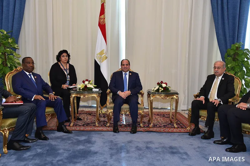 A handout photograph made available by the Egyptian Presidency shows shows Egyptian President Abdel Fattah al-Sisi (R) meeting with Prime Minister of Togo Kumi Silom Claso after the opening session of the 'Africa 2016, B...