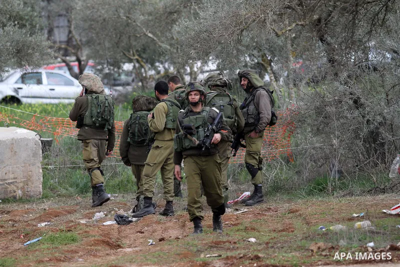 Israeli soldiers secure the scene after a Palestinian man who tried to stab an Israeli soldier before being shot dead, at the Bitot Junction south of Nablus in the northern occupied West Bank, on February 21, 2016. "A Pa...