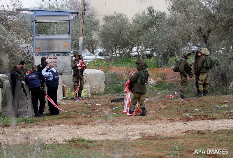 Israeli soldiers secure the scene after a Palestinian man who tried to stab an Israeli soldier before being shot dead, at the Bitot Junction south of Nablus in the northern occupied West Bank, on February 21, 2016. "A Pa...