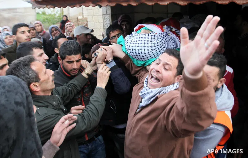 Mourners carry the the body of Palestinian teenager Qusay Abo Alrob, 16, whom the Israeli military said was shot dead by Israeli troops after he tried to stab a soldier on Sunday, during his funeral in the West Bank town...