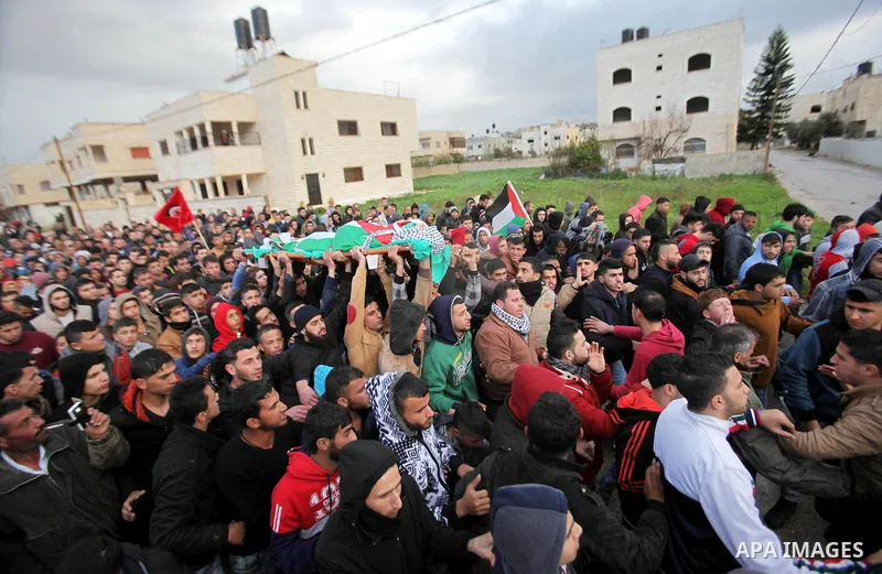 Mourners carry the the body of Palestinian teenager Qusay Abo Alrob, 16, whom the Israeli military said was shot dead by Israeli troops after he tried to stab a soldier on Sunday, during his funeral in the West Bank town...