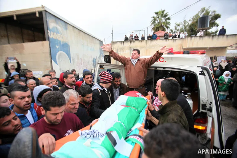 Mourners carry the the body of Palestinian teenager Qusay Abo Alrob, 16, whom the Israeli military said was shot dead by Israeli troops after he tried to stab a soldier on Sunday, during his funeral in the West Bank town...