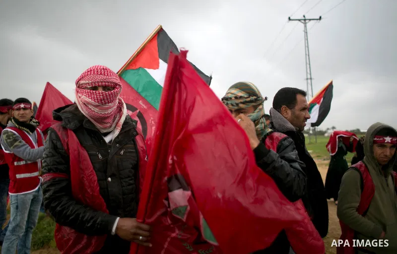 Palestinian supporters of the Democratic Front for the Liberation of Palestine (DFLP) shout slogans and hold flags of the movement during an anti-Israel protest marking the 47th anniversary of the DFLP establishment on F...