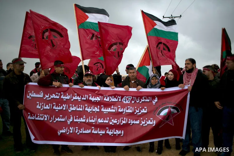 Palestinian supporters of the Democratic Front for the Liberation of Palestine (DFLP) shout slogans and hold flags of the movement during an anti-Israel protest marking the 47th anniversary of the DFLP establishment on F...
