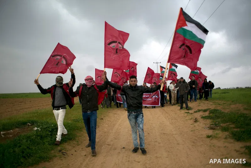 Palestinian supporters of the Democratic Front for the Liberation of Palestine (DFLP) shout slogans and hold flags of the movement during an anti-Israel protest marking the 47th anniversary of the DFLP establishment on F...