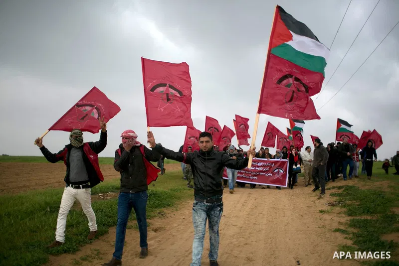 Palestinian supporters of the Democratic Front for the Liberation of Palestine (DFLP) shout slogans and hold flags of the movement during an anti-Israel protest marking the 47th anniversary of the DFLP establishment on F...