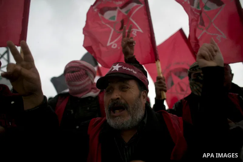 Palestinian supporters of the Democratic Front for the Liberation of Palestine (DFLP) shout slogans and hold flags of the movement during an anti-Israel protest marking the 47th anniversary of the DFLP establishment on F...