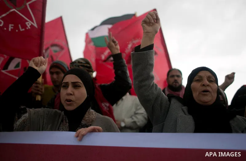 Palestinian supporters of the Democratic Front for the Liberation of Palestine (DFLP) shout slogans and hold flags of the movement during an anti-Israel protest marking the 47th anniversary of the DFLP establishment on F...