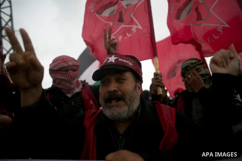 Palestinian supporters of the Democratic Front for the Liberation of Palestine (DFLP) shout slogans and hold flags of the movement during an anti-Israel protest marking the 47th anniversary of the DFLP establishment on F...