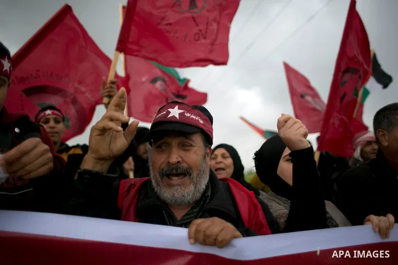 Palestinian supporters of the Democratic Front for the Liberation of Palestine (DFLP) shout slogans and hold flags of the movement during an anti-Israel protest marking the 47th anniversary of the DFLP establishment on F...