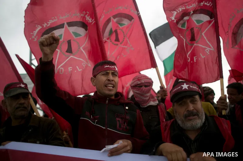 Palestinian supporters of the Democratic Front for the Liberation of Palestine (DFLP) shout slogans and hold flags of the movement during an anti-Israel protest marking the 47th anniversary of the DFLP establishment on F...