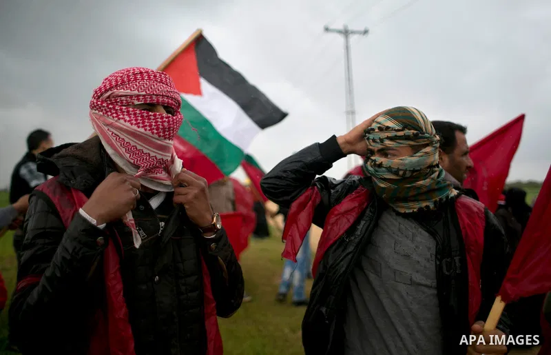 Palestinian supporters of the Democratic Front for the Liberation of Palestine (DFLP) shout slogans and hold flags of the movement during an anti-Israel protest marking the 47th anniversary of the DFLP establishment on F...