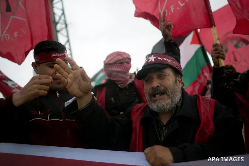 Palestinian supporters of the Democratic Front for the Liberation of Palestine (DFLP) shout slogans and hold flags of the movement during an anti-Israel protest marking the 47th anniversary of the DFLP establishment on F...