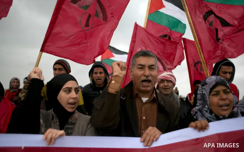 Palestinian supporters of the Democratic Front for the Liberation of Palestine (DFLP) shout slogans and hold flags of the movement during an anti-Israel protest marking the 47th anniversary of the DFLP establishment on F...