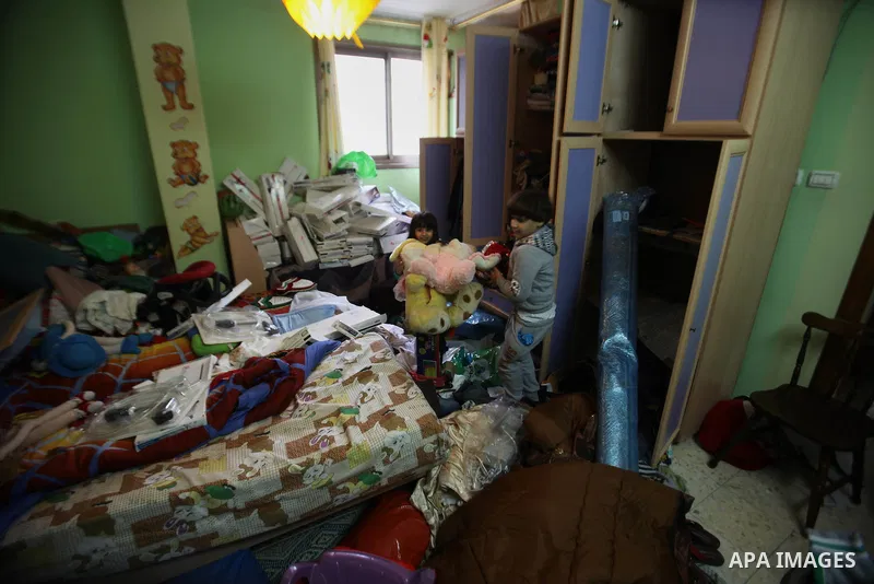 Palestinian children play in the bedroom after Israeli troops searched apartments belonging to a same family during an operation to arrest wanted Palestinians in the Askar refugee camp, near Nablus in the Israeli occupie...
