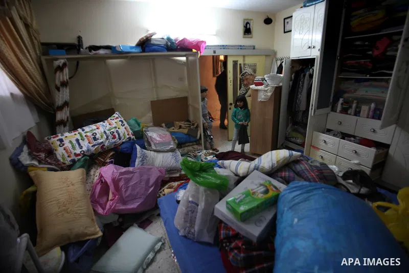 A Palestinian girl looks at the bedroom after Israeli troops searched apartments belonging to a same family during an operation to arrest wanted Palestinians in the Askar refugee camp, near Nablus in the Israeli occupied...