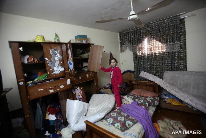 A Palestinian girl looks at the bedroom after Israeli troops searched apartments belonging to a same family during an operation to arrest wanted Palestinians in the Askar refugee camp, near Nablus in the Israeli occupied...