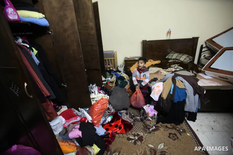 A Palestinian boy looks at the bedroom after Israeli troops searched apartments belonging to a same family during an operation to arrest wanted Palestinians in the Askar refugee camp, near Nablus in the Israeli occupied...