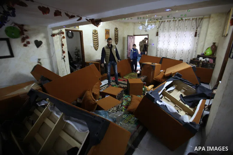 A Palestinian man looks at the bedroom after Israeli troops searched apartments belonging to a same family during an operation to arrest wanted Palestinians in the Askar refugee camp, near Nablus in the Israeli occupied...