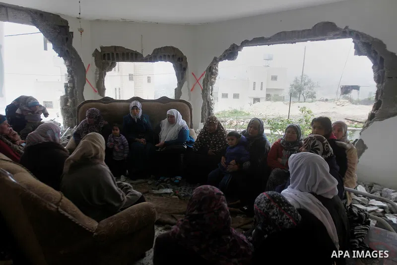 Palestinians check the damage in a house after it was partially demolished by Israeli forces in the West Bank village of Deir Samit, south of Hebron February 23, 2016. Israeli army on Tuesday demolished houses of two Pal...