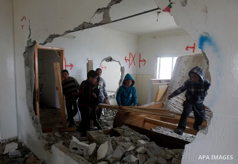 Palestinians check the damage in a house after it was partially demolished by Israeli forces in the West Bank village of Deir Samit, south of Hebron February 23, 2016. Israeli army on Tuesday demolished houses of two Pal...