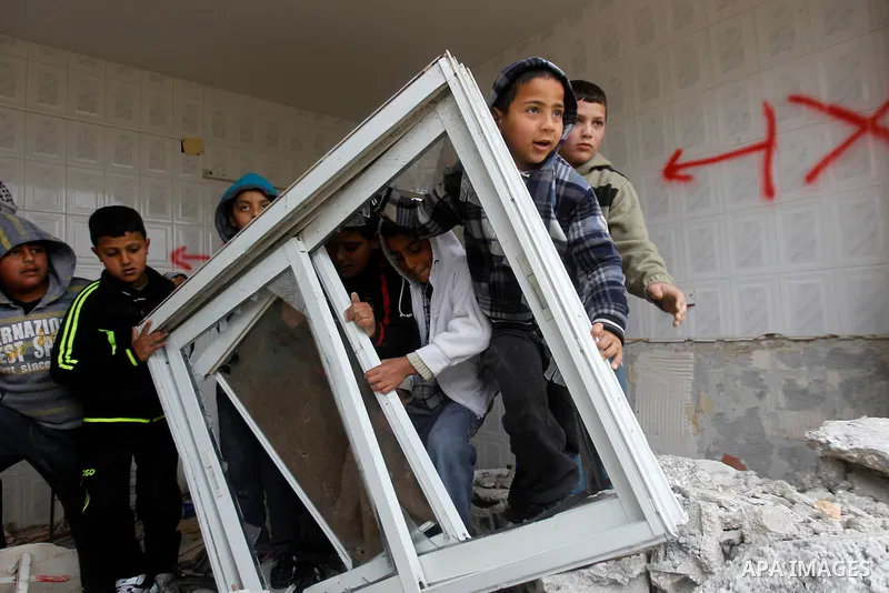 Palestinians check the damage in a house after it was partially demolished by Israeli forces in the West Bank village of Deir Samit, south of Hebron February 23, 2016. Israeli army on Tuesday demolished houses of two Pal...