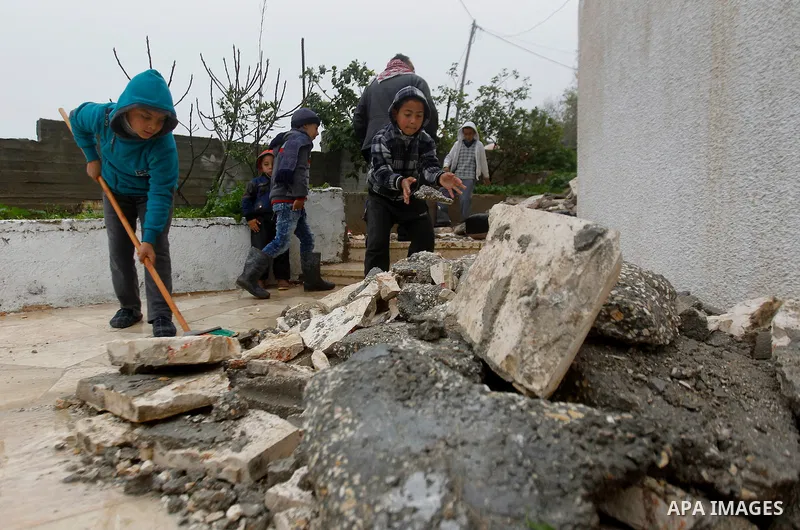 Palestinians check the damage in a house after it was partially demolished by Israeli forces in the West Bank village of Deir Samit, south of Hebron February 23, 2016. Israeli army on Tuesday demolished houses of two Pal...