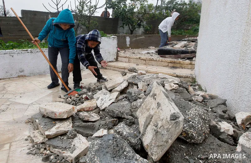Palestinians check the damage in a house after it was partially demolished by Israeli forces in the West Bank village of Deir Samit, south of Hebron February 23, 2016. Israeli army on Tuesday demolished houses of two Pal...