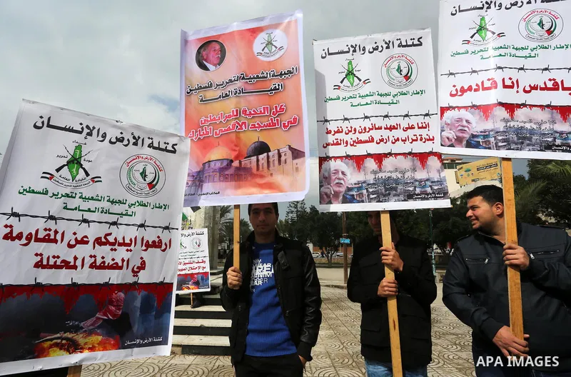 Palestinians hold posters bearing a portrait of Palestinian journalist Mohammed al-Qiq who is imprisoned in an Israeli jail during a protest in support of his hunger strike in Gaza city on Feb. 23, 2016. Photo by Mohamme...