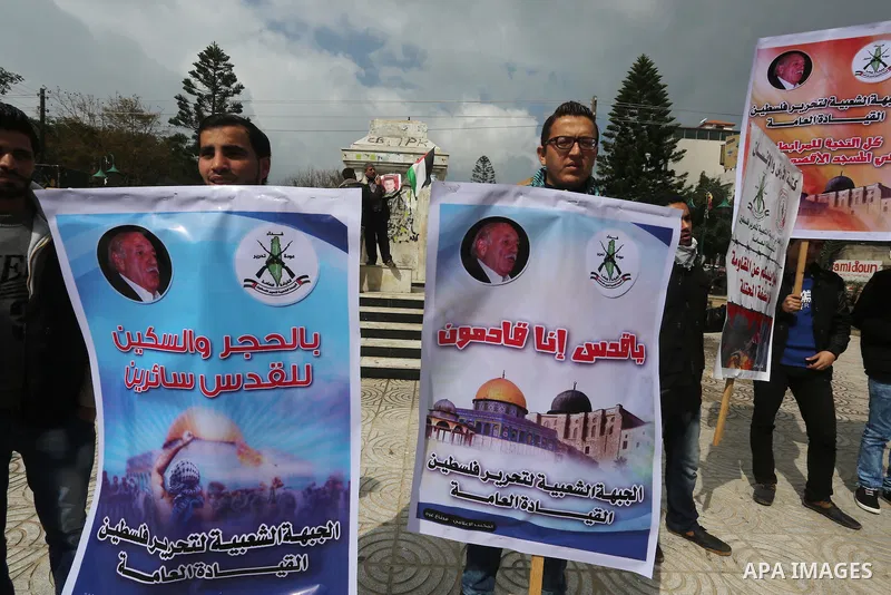 Palestinians hold posters bearing a portrait of Palestinian journalist Mohammed al-Qiq who is imprisoned in an Israeli jail during a protest in support of his hunger strike in Gaza city on Feb. 23, 2016. Photo by Mohamme...