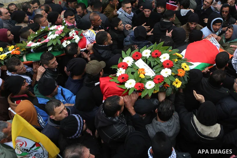 Palestinian mourners carry the bodies of Mansour al-Shawamrah, 20, and Omar Amr, 20 during their joint funeral in the West Bank village of al-Qubeiba, near Ramallah, Tuesday, Feb. 23, 2016. Israeli police said that the t...