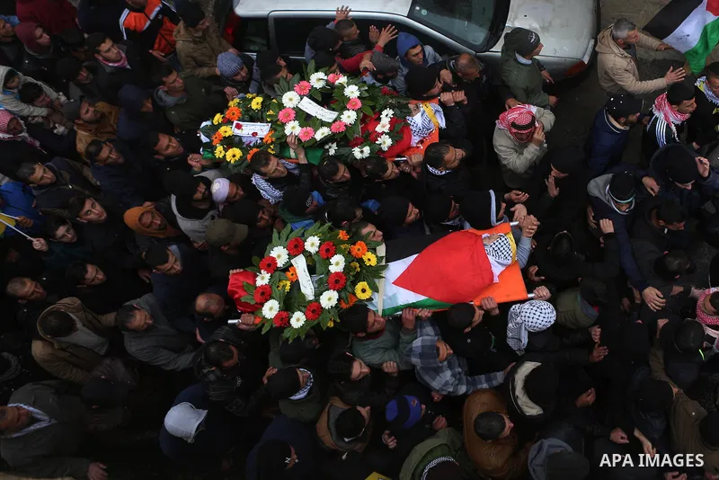 Palestinian mourners carry the bodies of Mansour al-Shawamrah, 20, and Omar Amr, 20 during their joint funeral in the West Bank village of al-Qubeiba, near Ramallah, Tuesday, Feb. 23, 2016. Israeli police said that the t...