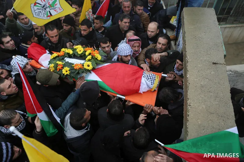 Palestinian mourners carry the body of one of two Palestinians, who the Israeli military said were fatally shot by Israeli police officers after they opened fire at them outside Jerusalem's walled Old City on February 14...