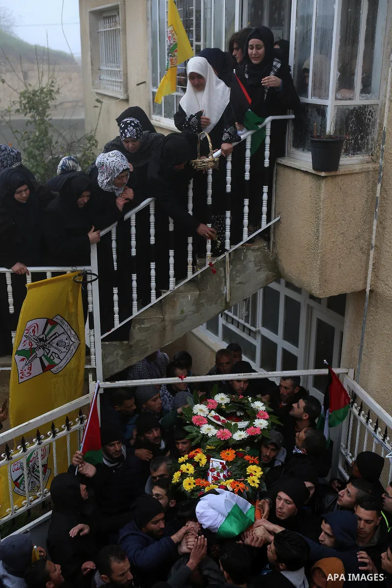 Palestinian mourners carry the body of one of two Palestinians, who the Israeli military said were fatally shot by Israeli police officers after they opened fire at them outside Jerusalem's walled Old City on February 14...