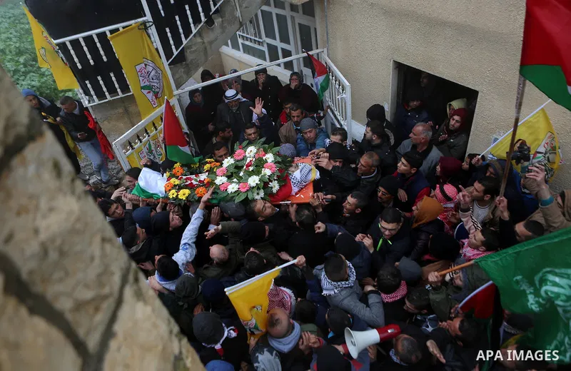 Palestinian mourners carry the body of one of two Palestinians, who the Israeli military said were fatally shot by Israeli police officers after they opened fire at them outside Jerusalem's walled Old City on February 14...